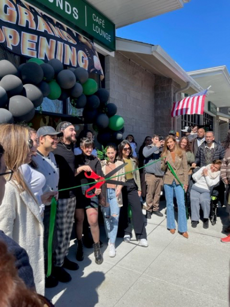Owners and staff of Common Grounds café and lounge cutting the ribbon on March 26, 2023.