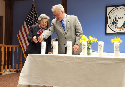 Esther Geizhals and Councilman Ed Lachterman light candles at Yorktown’s annual Holocaust Remembrance Ceremony on April 21, 2022